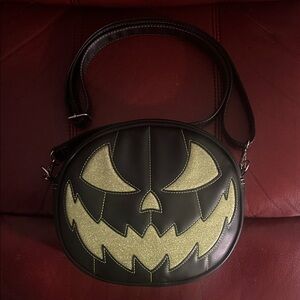 Love, Pain and Stitches black/green glitter pumpkin face crossbody bag